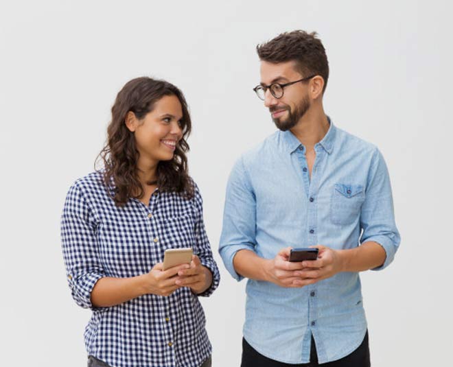 couple using cellphones inside