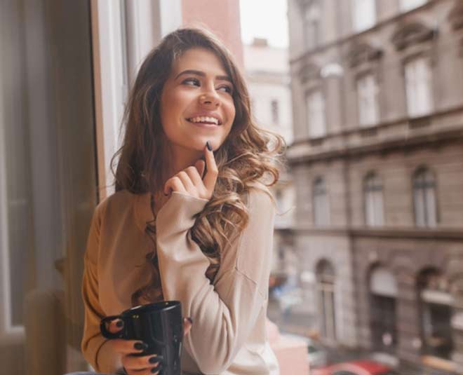 woman touching chin inside