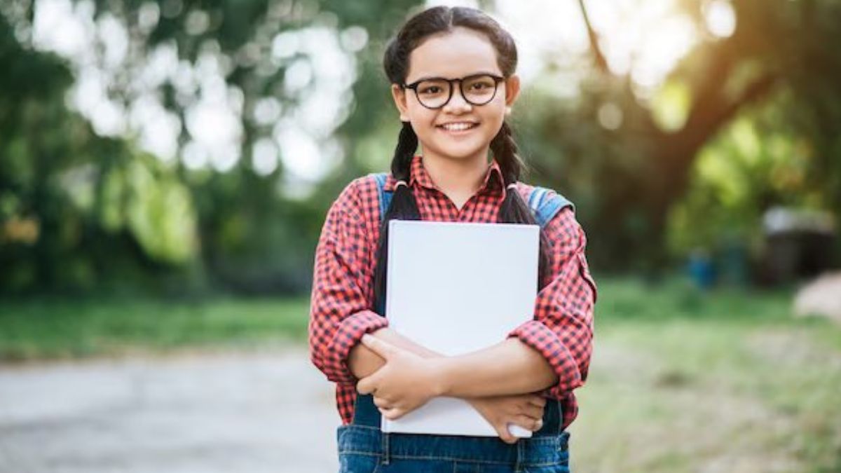 student with book in her hand
