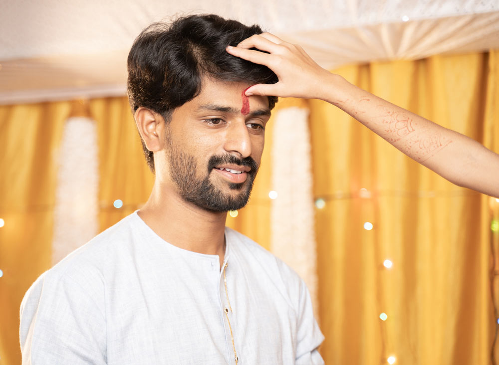 applying tilak on forehead
