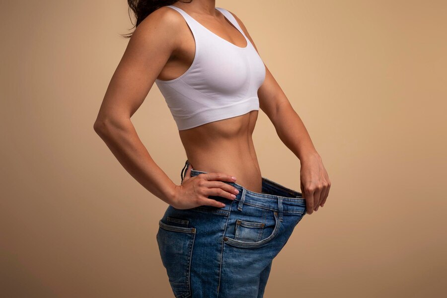 cropped lady big jeans demonstrating results diet