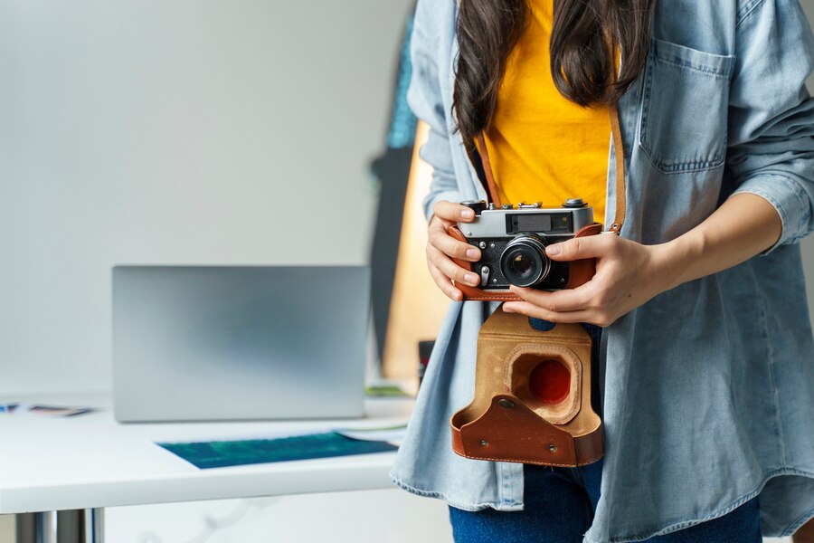close up woman holding small camera