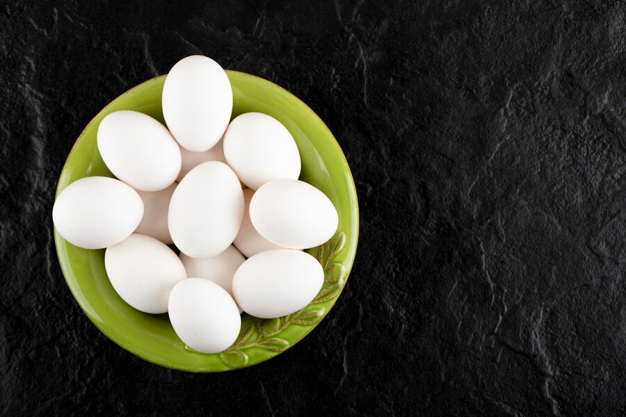 bunch raw eggs green plate