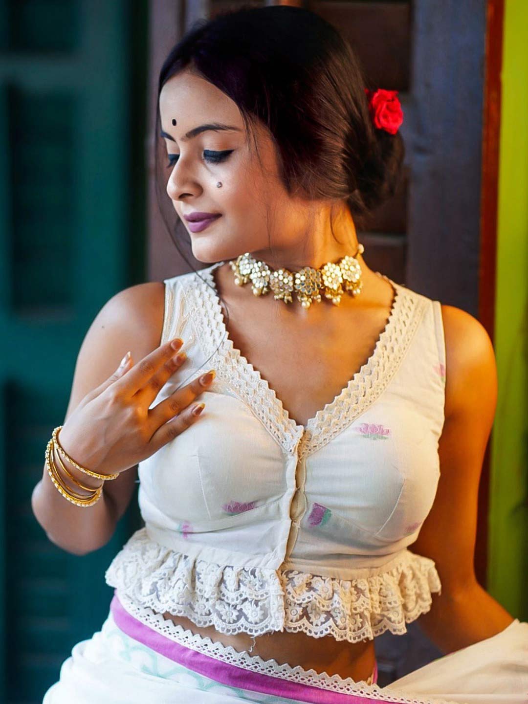 White Sleeveless V Neck Blouse With Lace Work On The Neckline And Hem