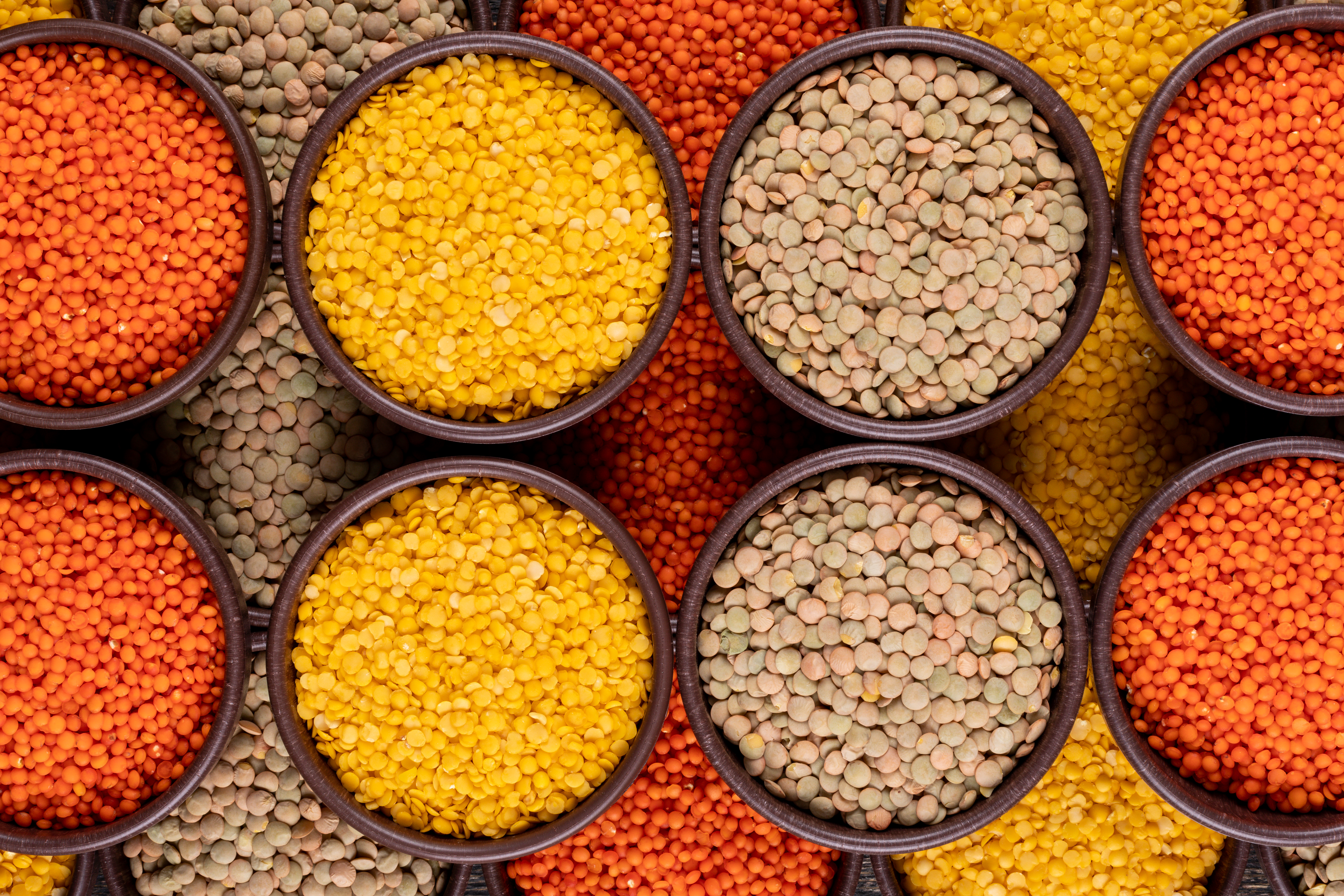 yellow-green-red-lentils-brown-bowls-close-up