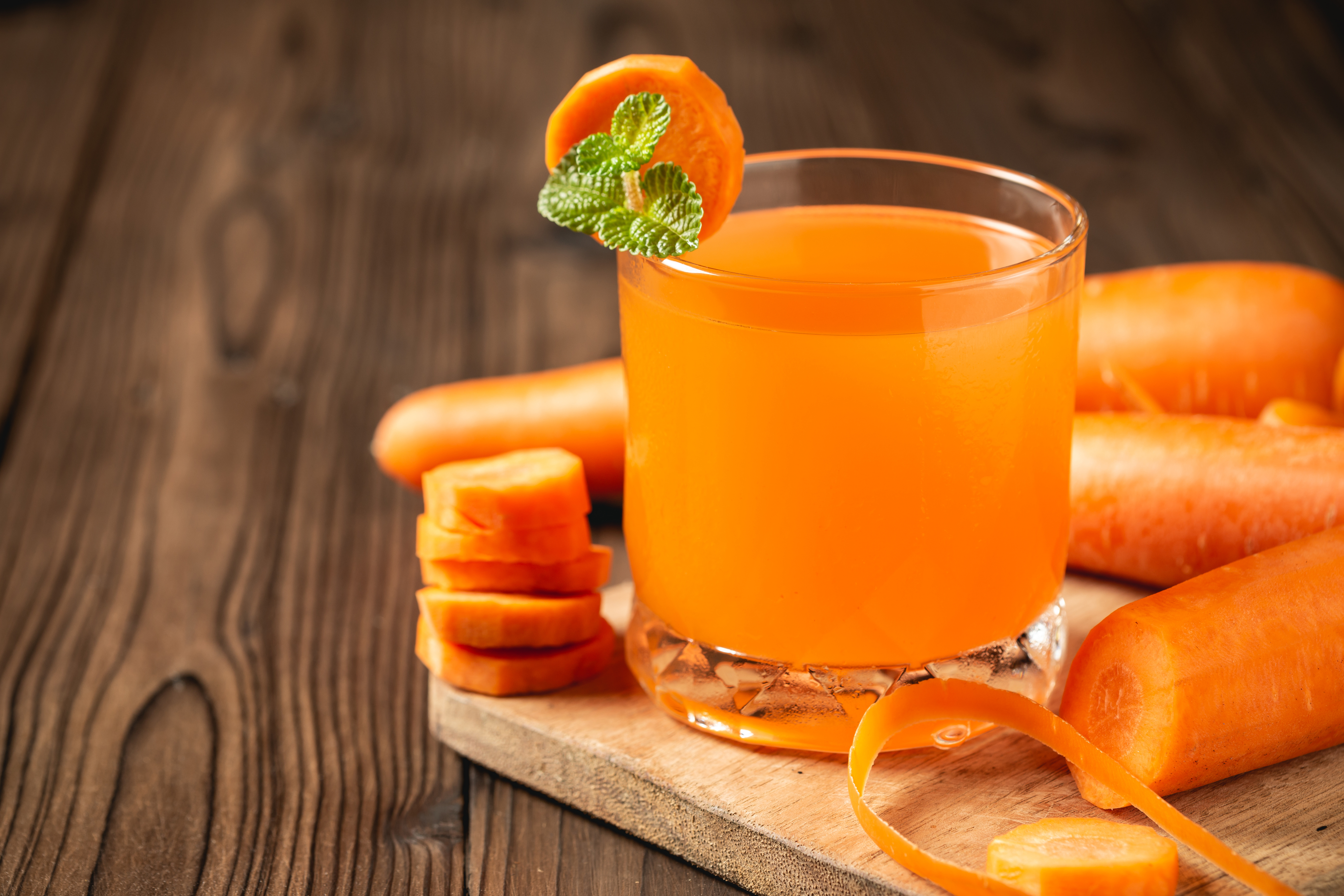 carrot-juice-glass-wooden-table