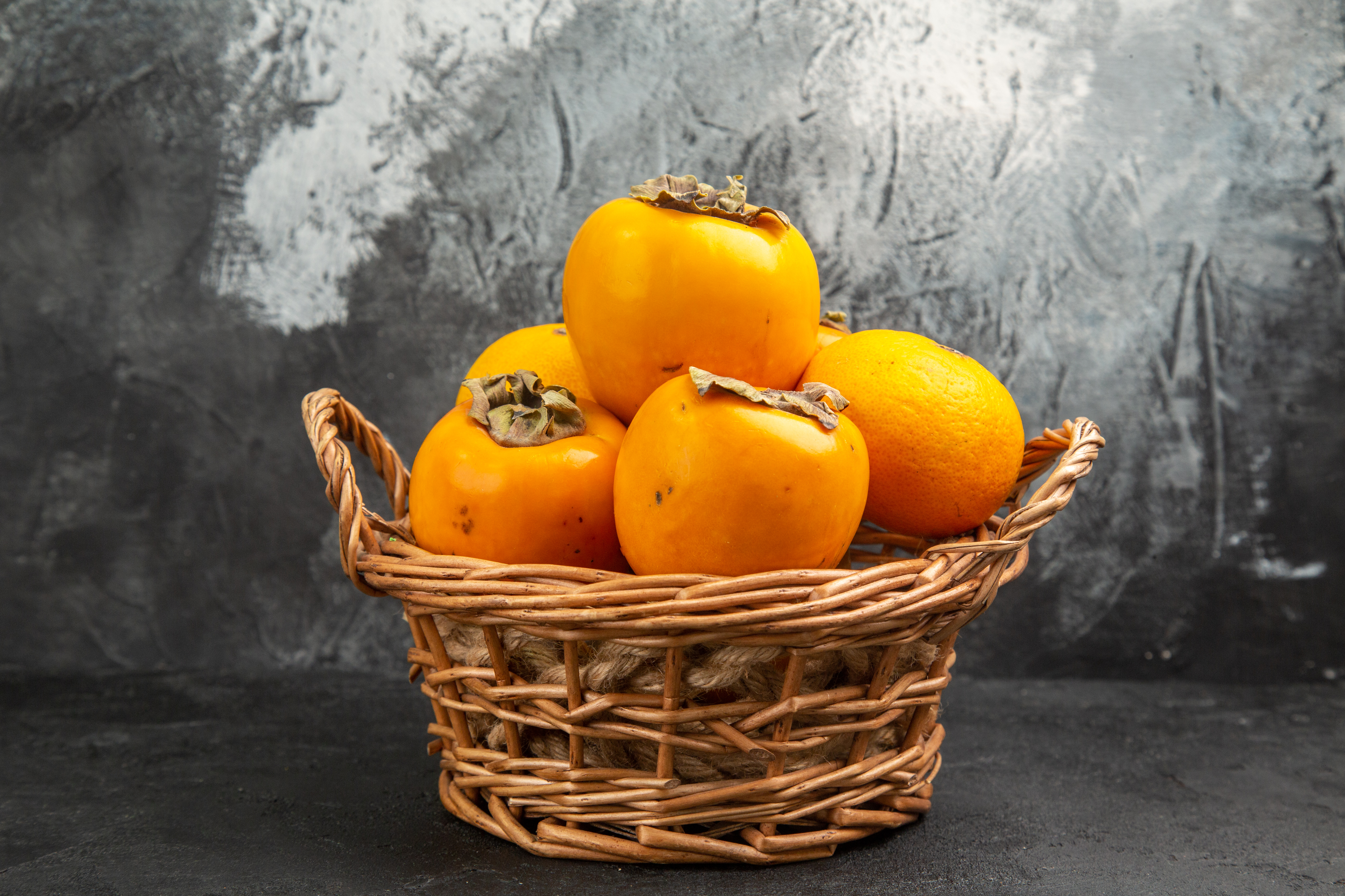 front-view-fresh-sweet-persimmons-inside-basket-dark-table