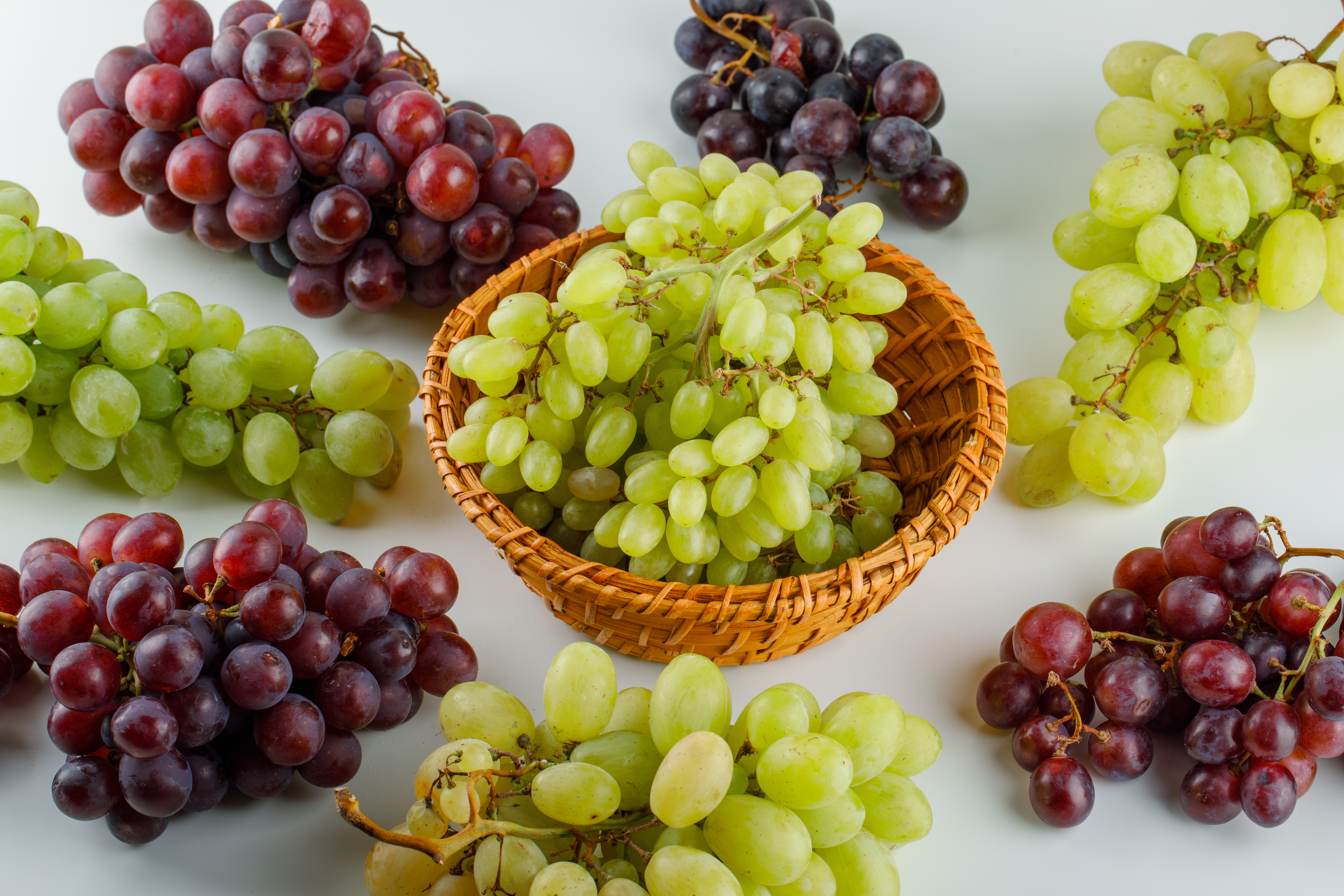 ripe-grapes-wicker-basket-high-angle-view-white