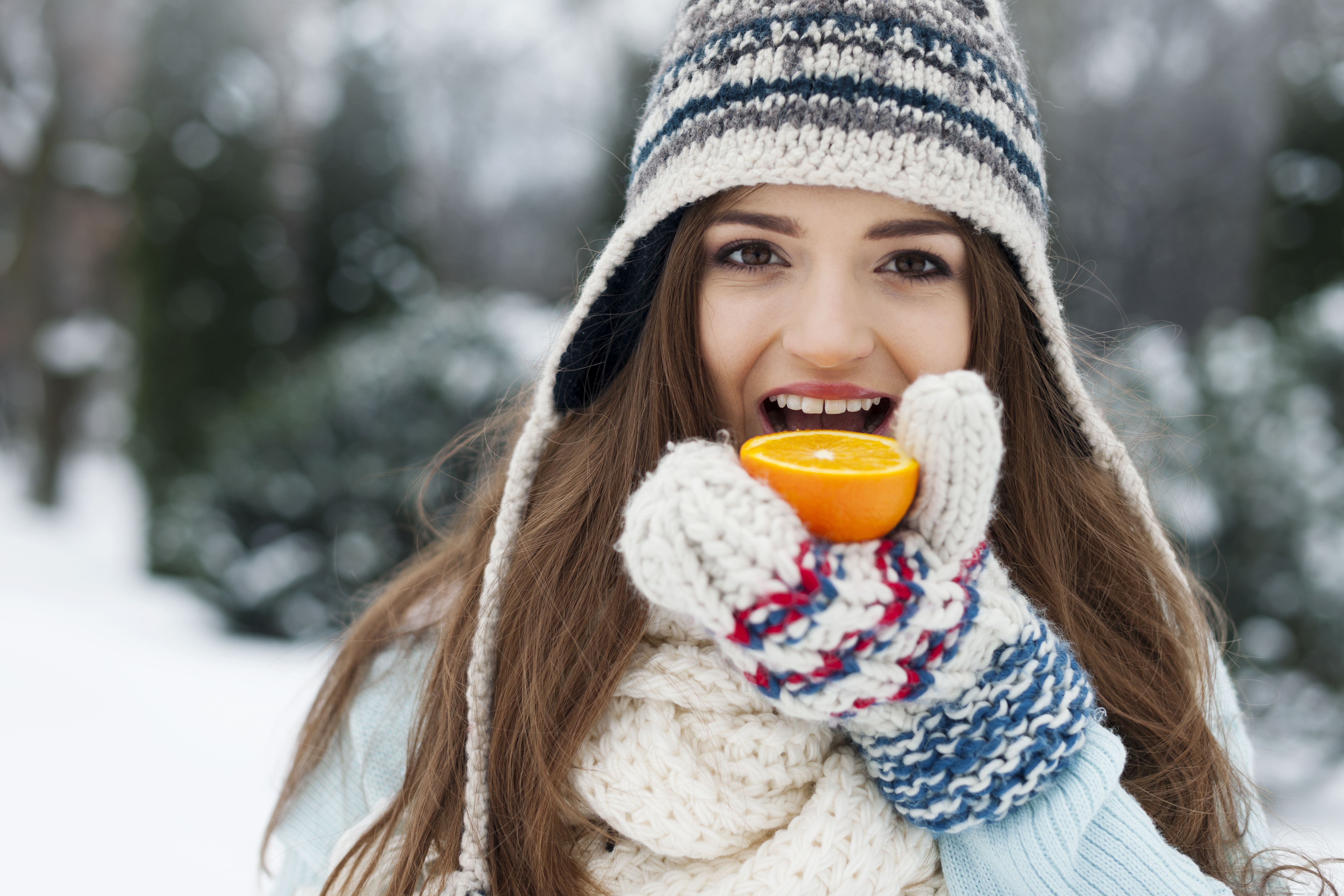 woman-eating-orange-winter-time