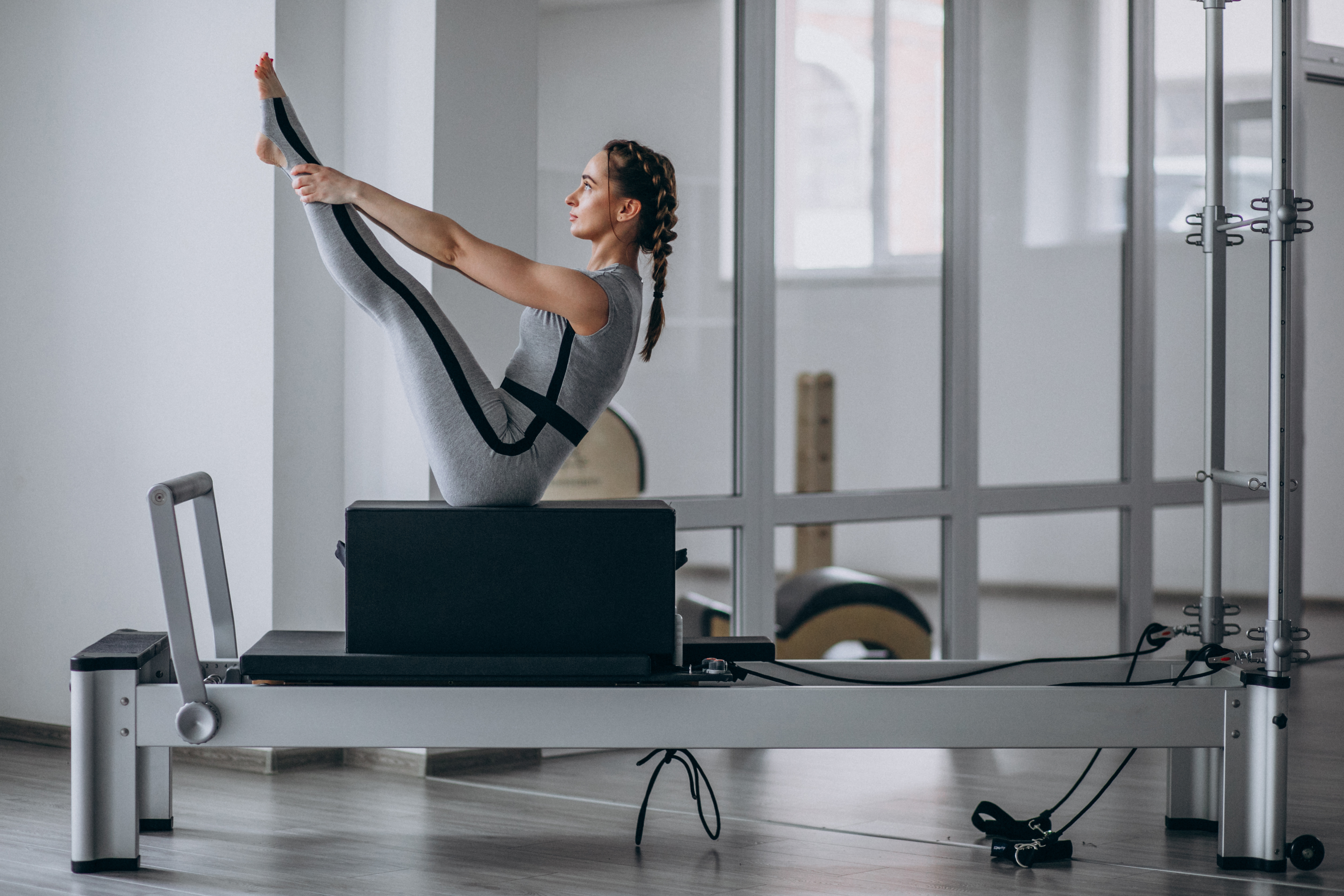 woman-practising-pilates-pilates-reformer