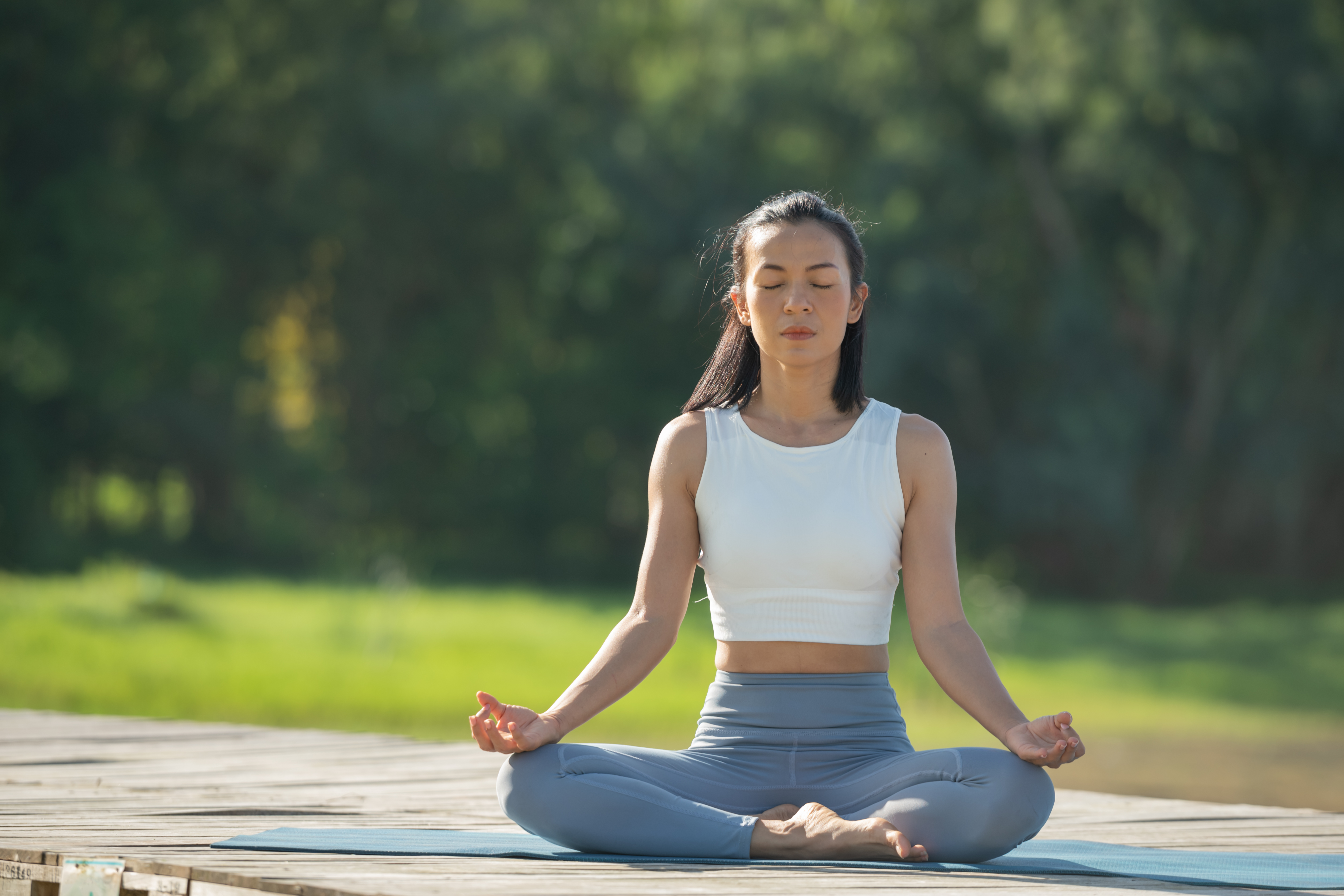 woman-yoga-mat-relax-park-mountain-lake-calm-woman-with-closed-eyes-practicing-yoga-sitting-padmasana-pose-mat-lotus-exercise-attractive-sporty-girl-sportswear
