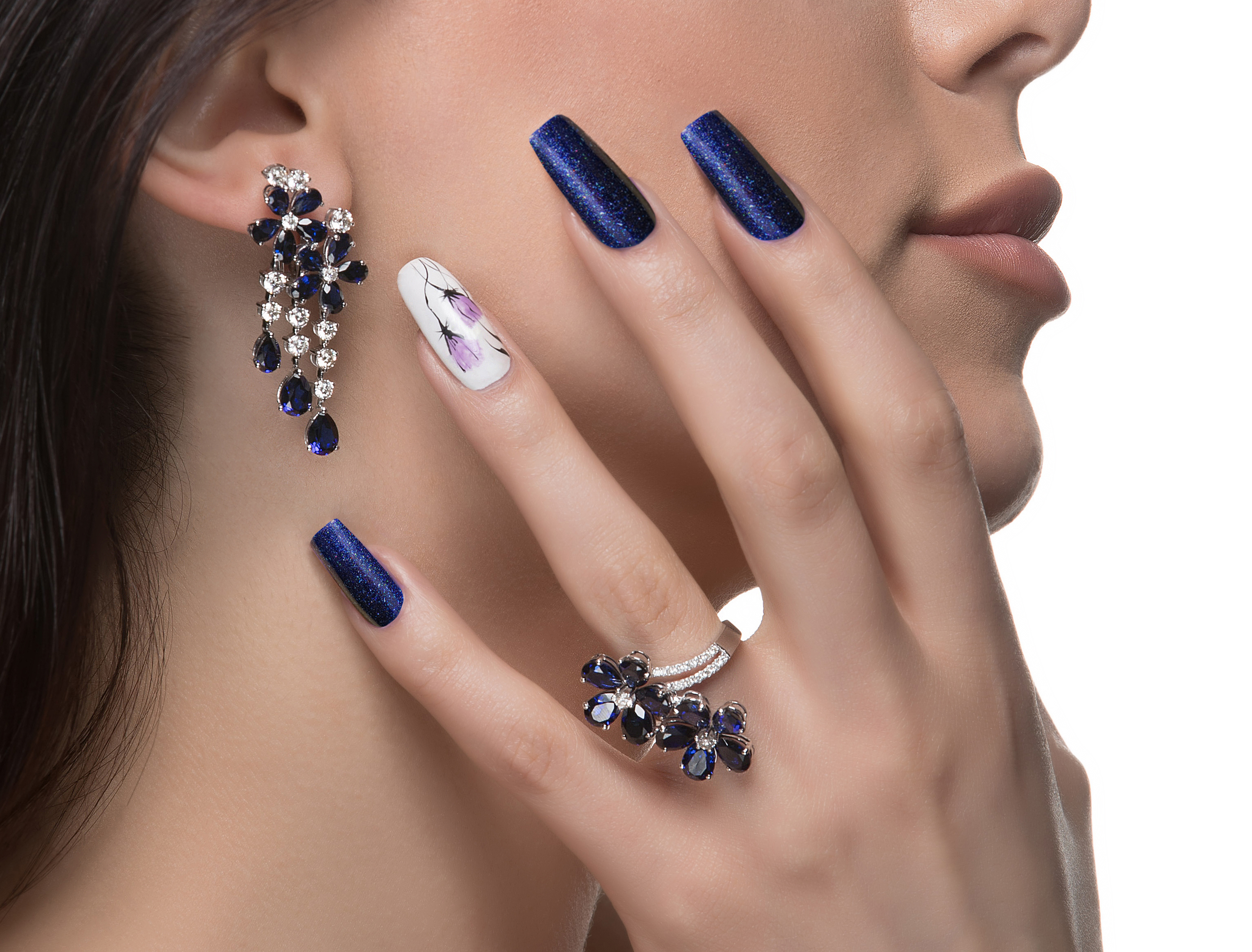 woman-with-nail-art-promoting-design-luxury-earrings-ring