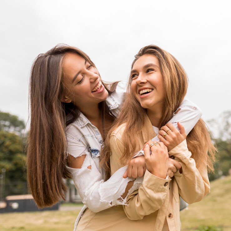 happy-friends-hugging-outoors_23-2148720190