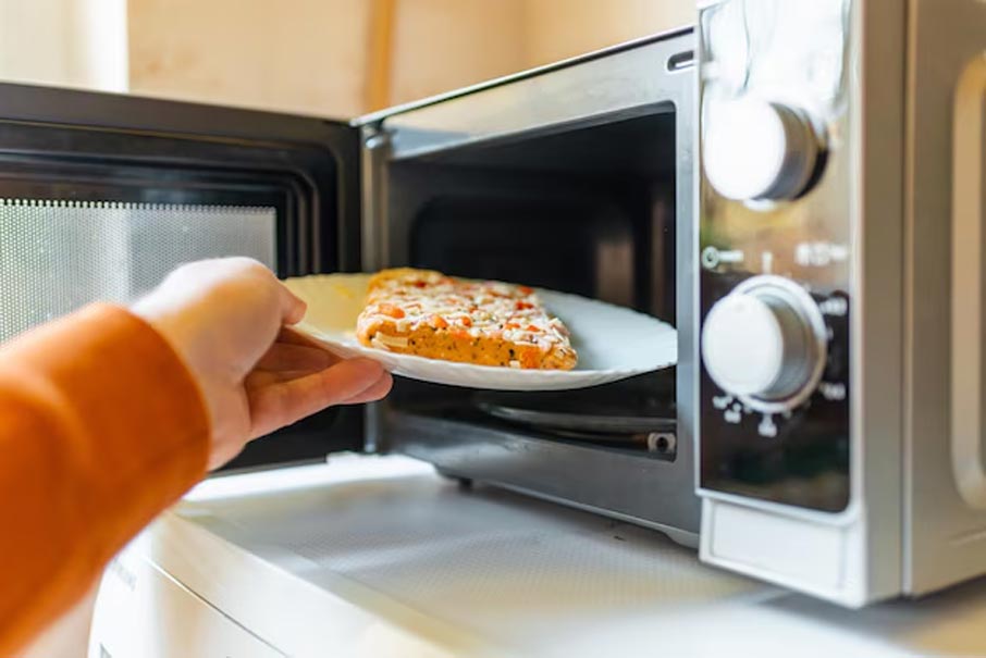 What should you be careful of when using a microwave to cook