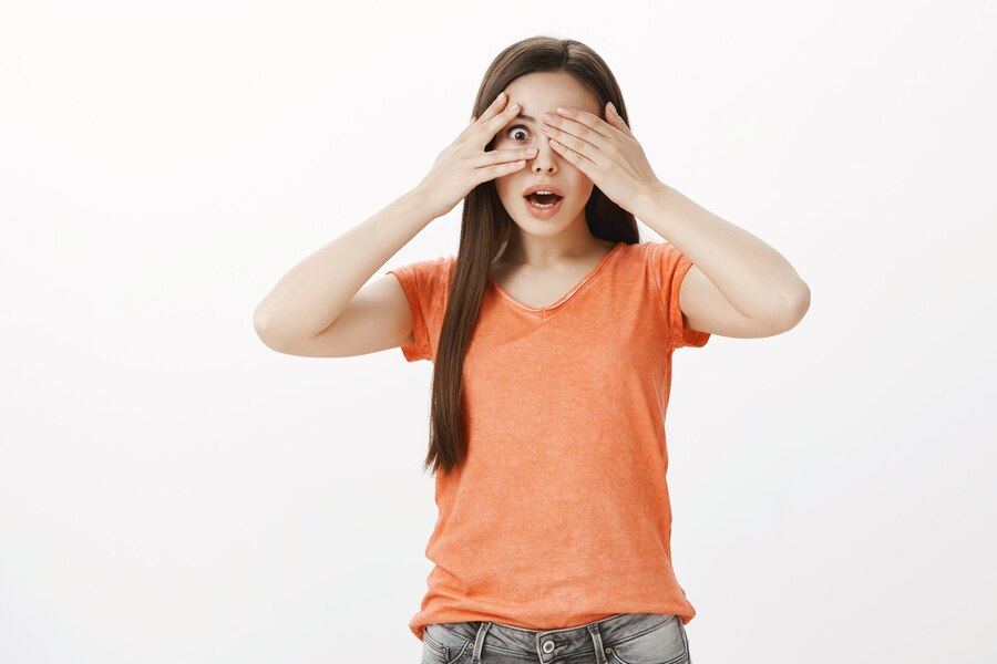 dreamy-hopeful-smiling-woman-close-eyes-peeking-through-fingers-impressed_176420-25358