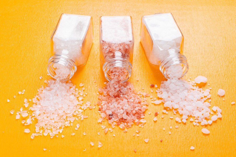 some-sea-salt-with-himalayan-salt-coming-out-salt-shaker_176474-1789