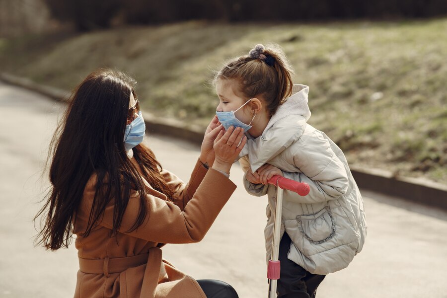 mother wearing mask to her daughter