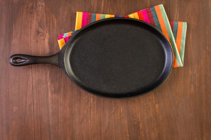 How do I season my cast iron tawa