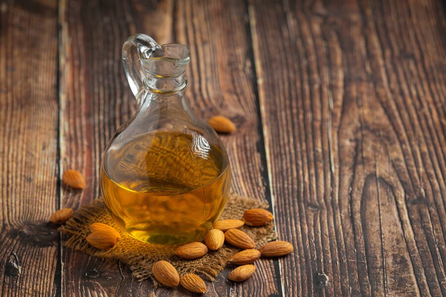 almond-oil-bottle-dark-wood-background_1150-45141