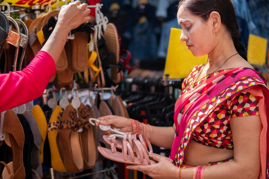 side-view-woman-wearing-sari-looking-sandals-market_1048944-26097278