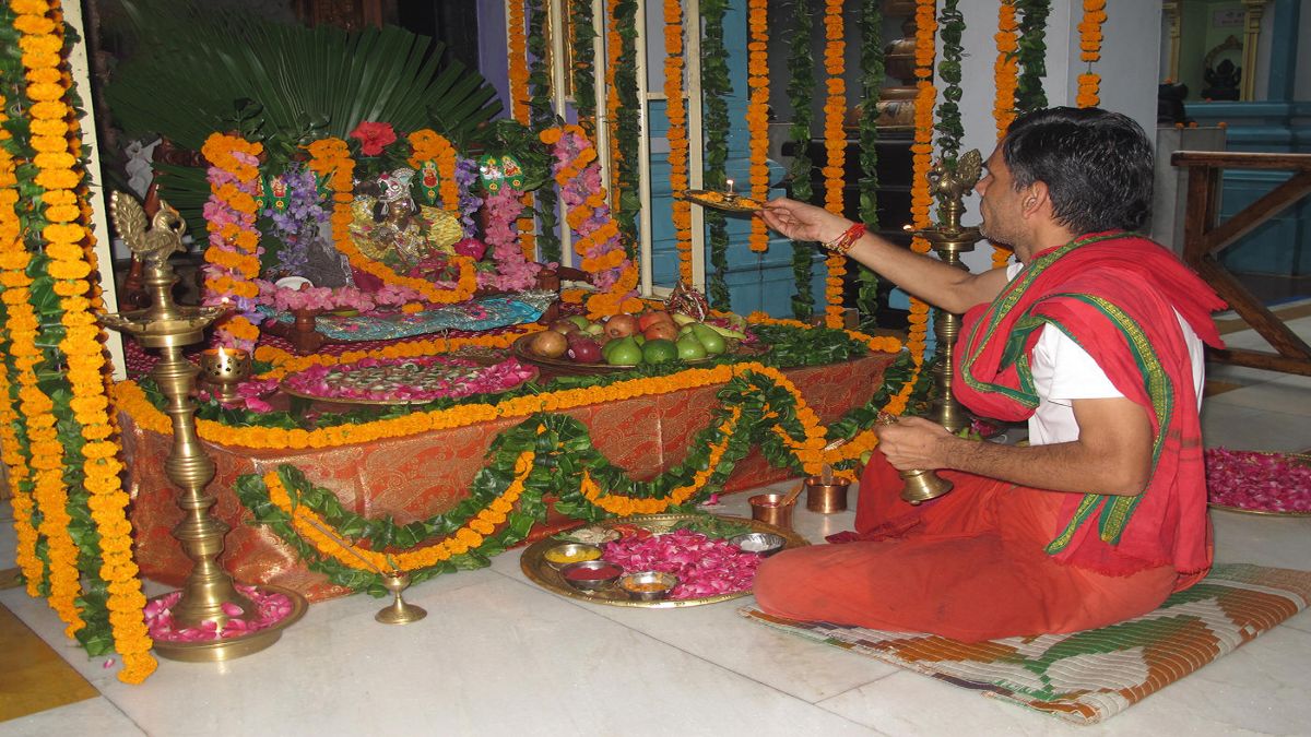 what happens if we touch feet of pandit while he is performing puja