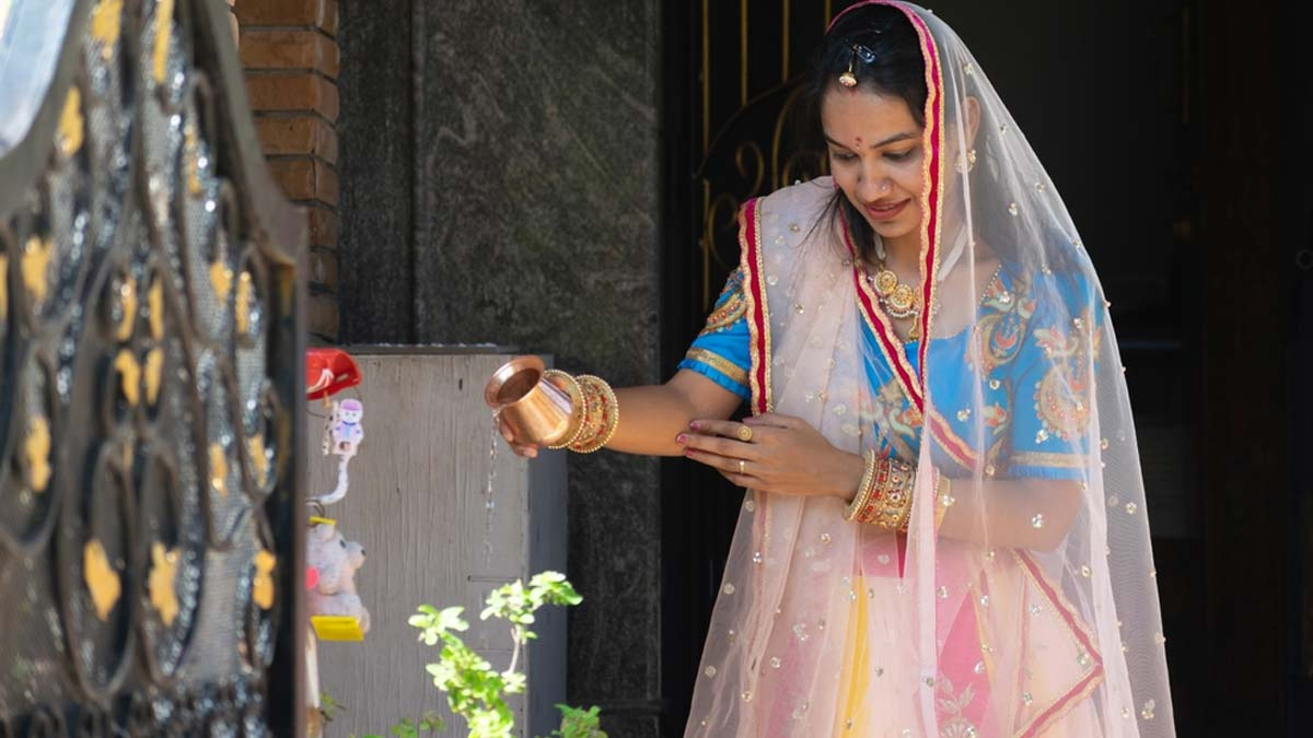 offering water to tulsi plant