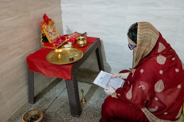 woman doing pooja in red saree