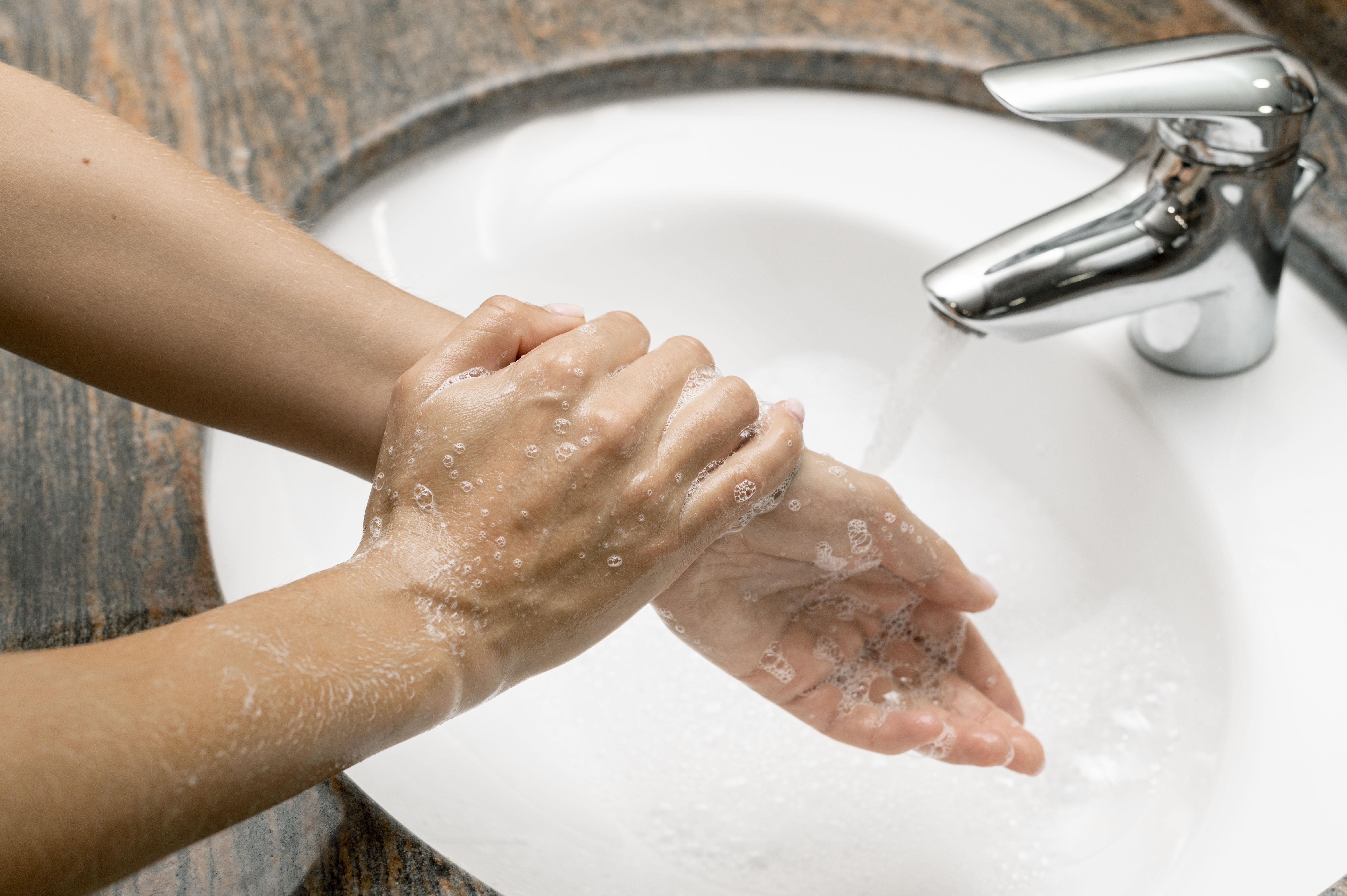 high-angle-woman-washing-hands