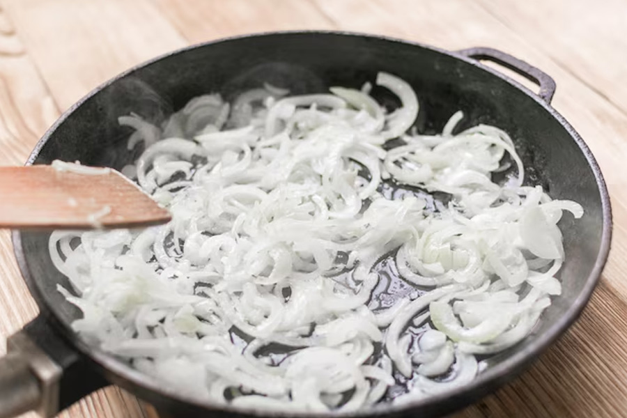 What does adding baking soda to onions do