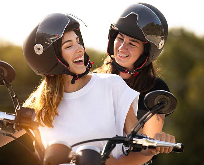 Which girls are allowed to ride a scooter without a helmet