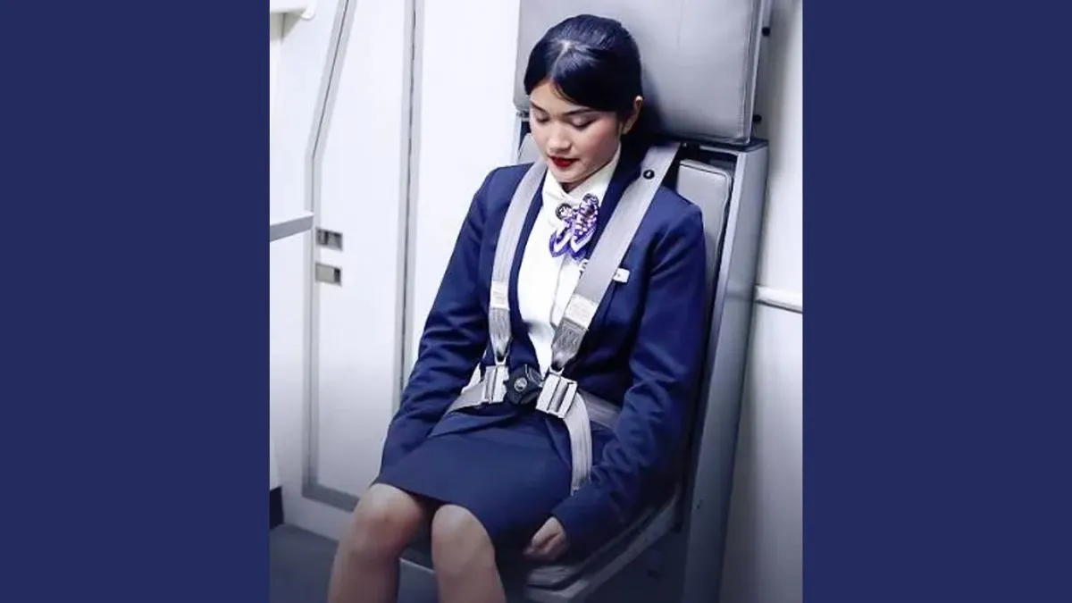 why do flight attendants sit on their hands (1)