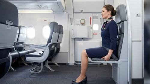 why do flight attendants sit on their hands