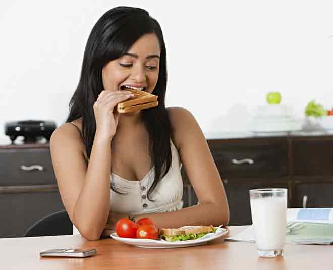 mother eating breakfast in