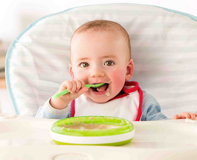 baby eating food inside
