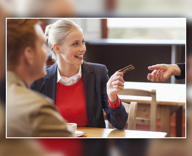 women paying at restaurant
