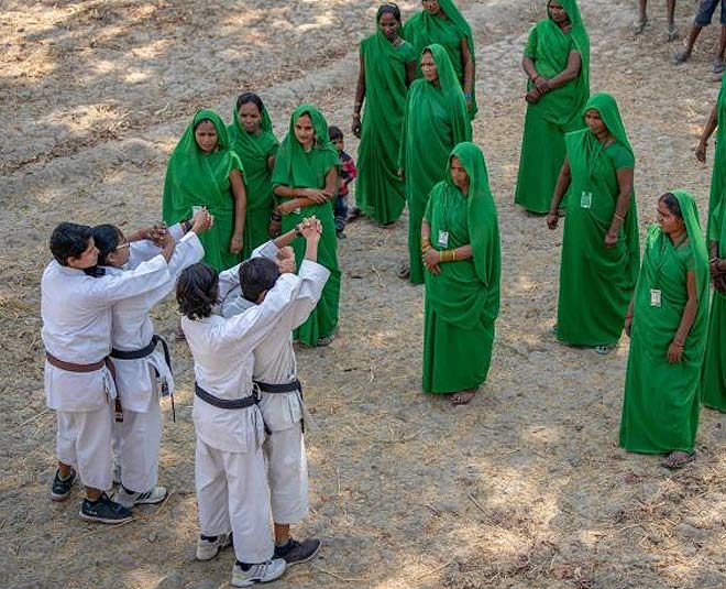 women learning marshal arts inside 