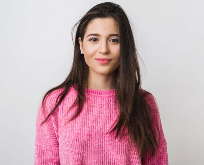 women in pick sweater inside 