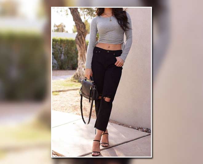 long sleeve black crop top paired with blue boyfriend jeans