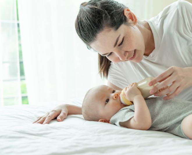 baby drinking milk inside 