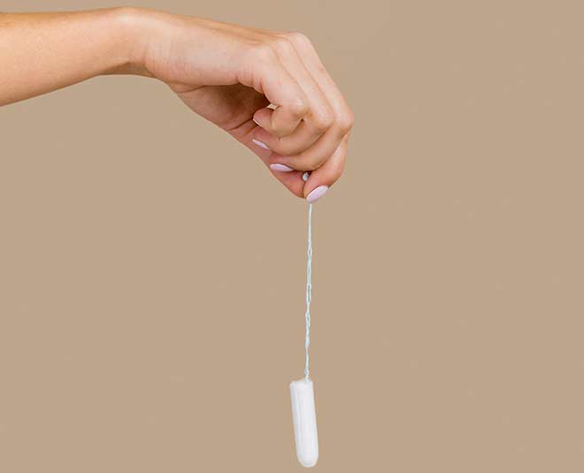 hand holding tampon