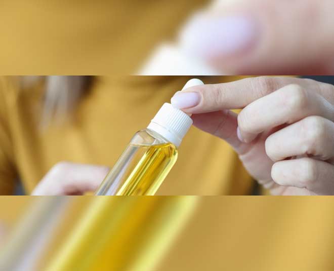 applying oil onto her hair inside 