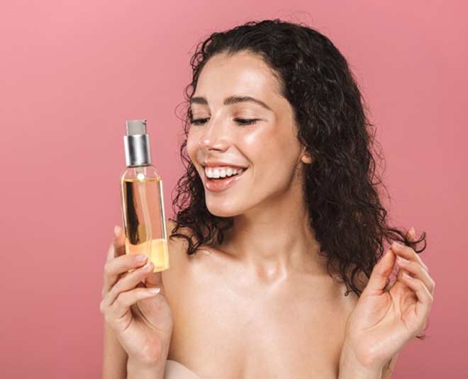 woman holding jar hair oil her hands inside 