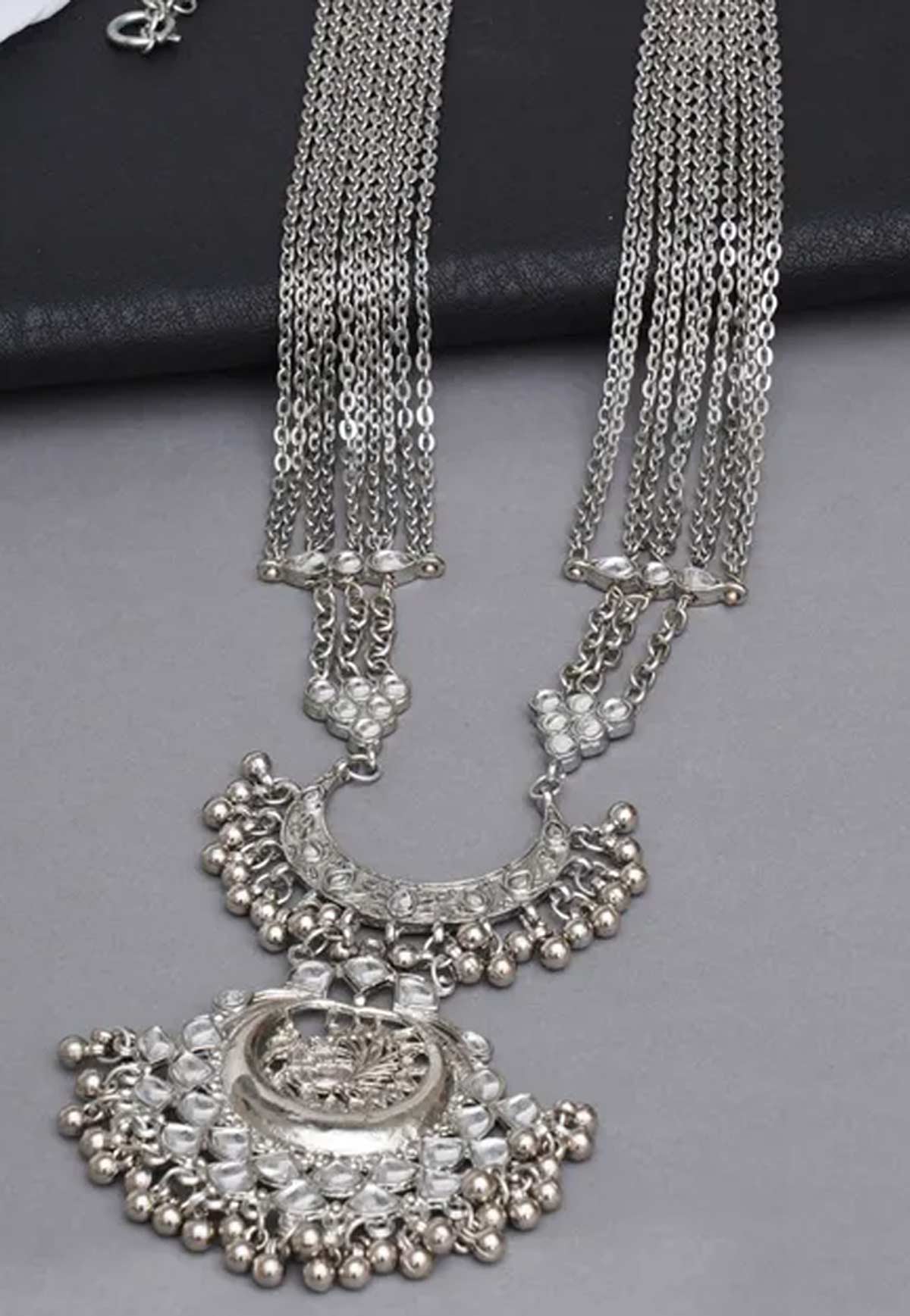 boat neck with long chain jewellery