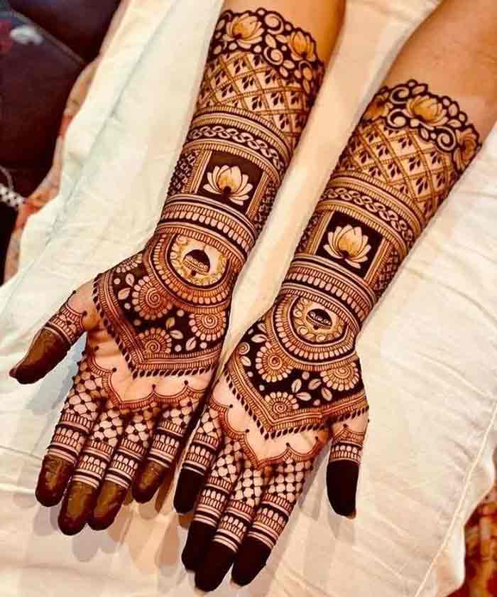 Beautiful woman dressed up as Indian tradition with henna mehndi design on  her both hands to celebrate big festival of Karwa Chauth with plain white b  Stock Photo - Alamy