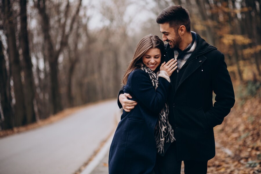 young couple together walking autumn park