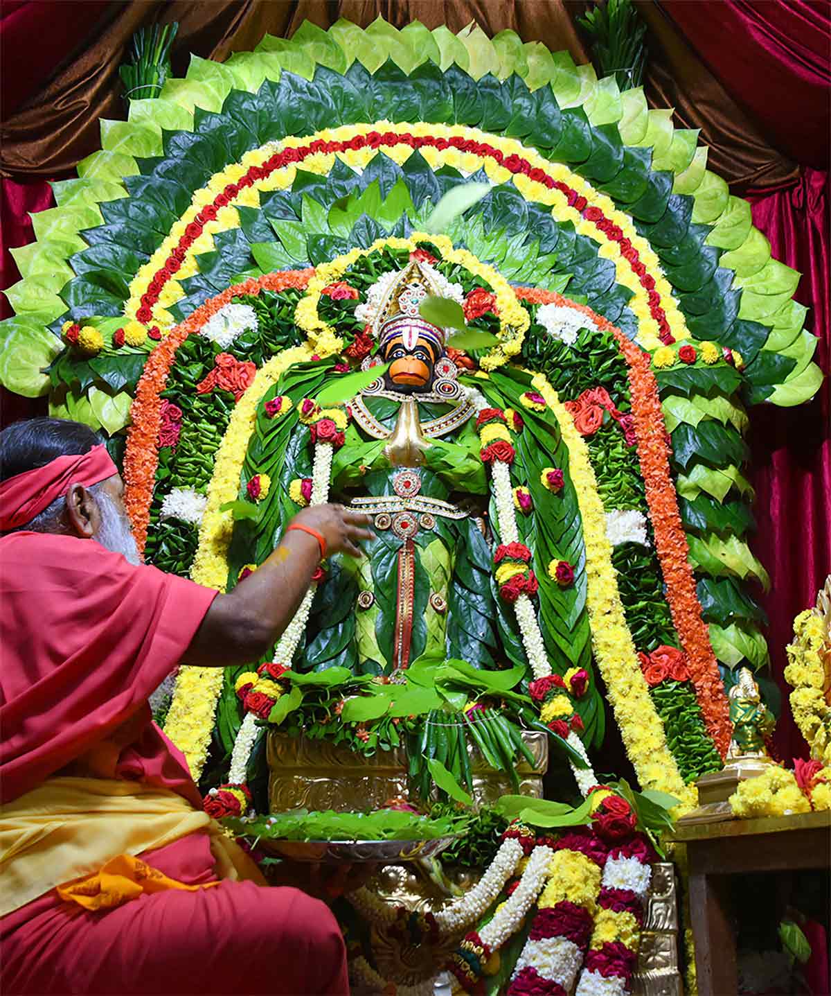 offering betel leaves to hanuman ji