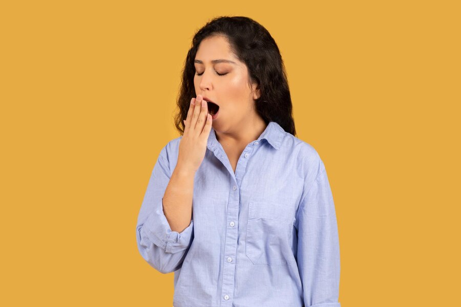 tired young woman yawning