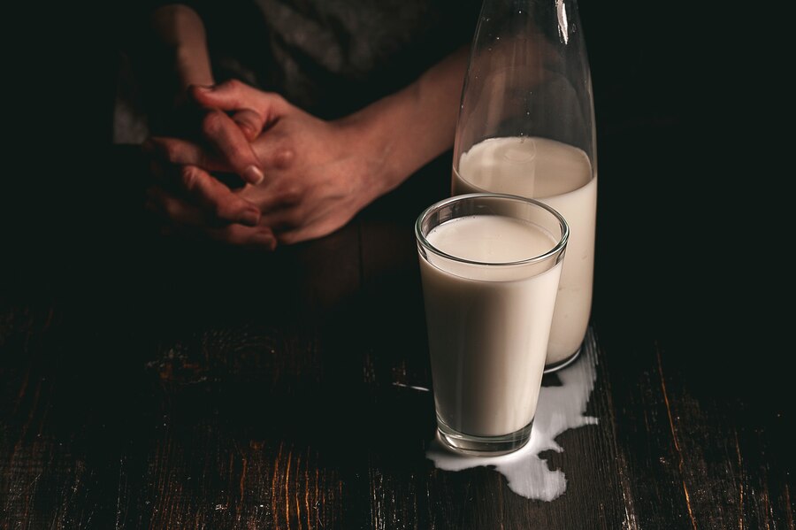 woman farmer with glass milk concept problems agricultural sector  