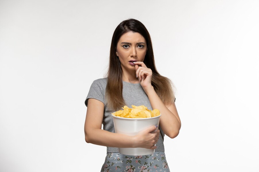 front view young female holding chips watching movie white surface  