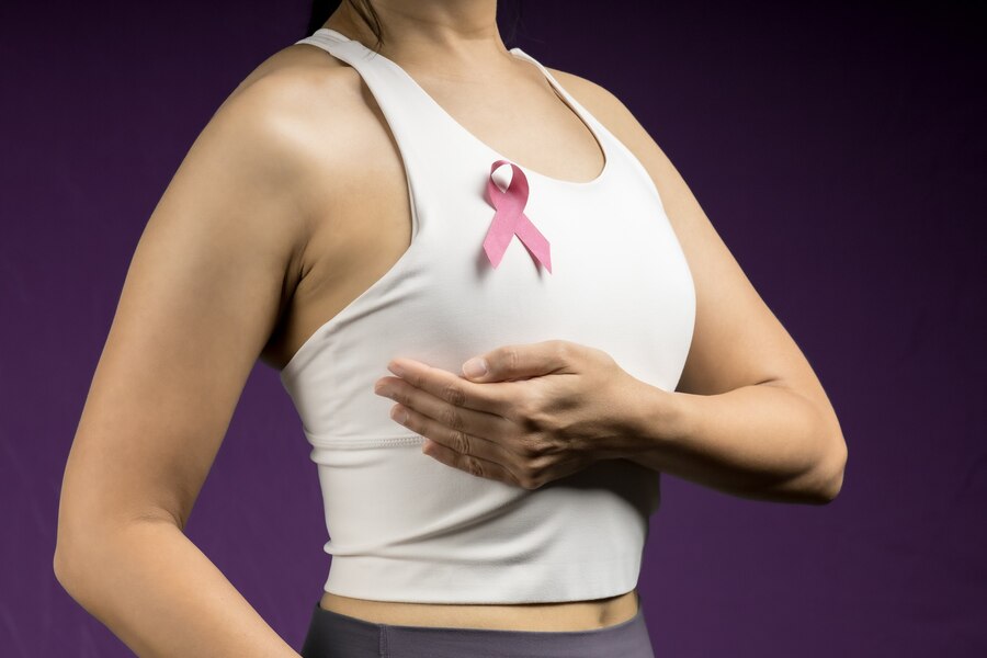 adult woman with pink ribbon represent breast cancer awareness  